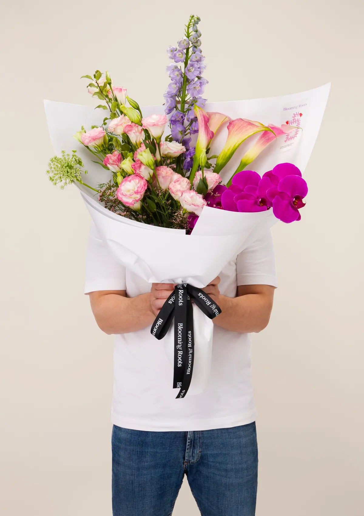 A man holding Bridgerton Bouquet from Blooming Roots.