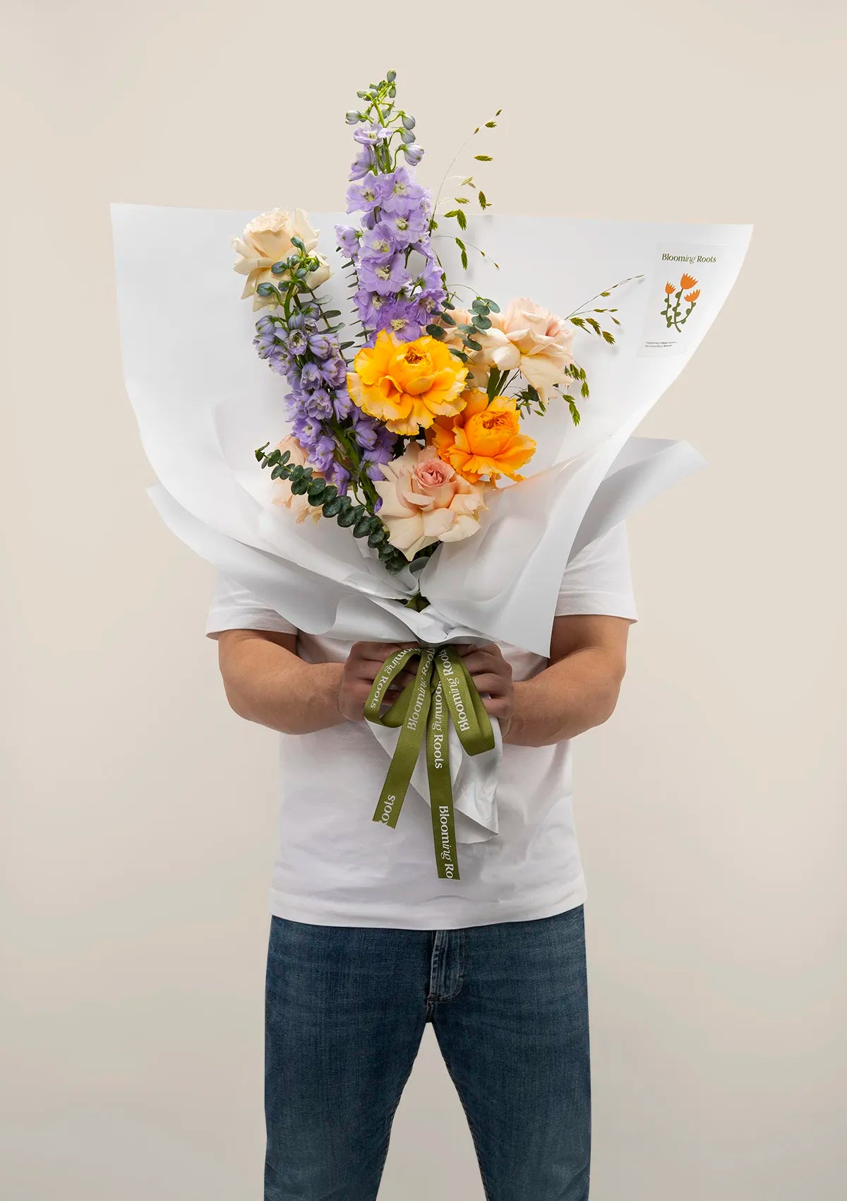 A man holding Coastal Majesty Bouquet from Blooming Roots.