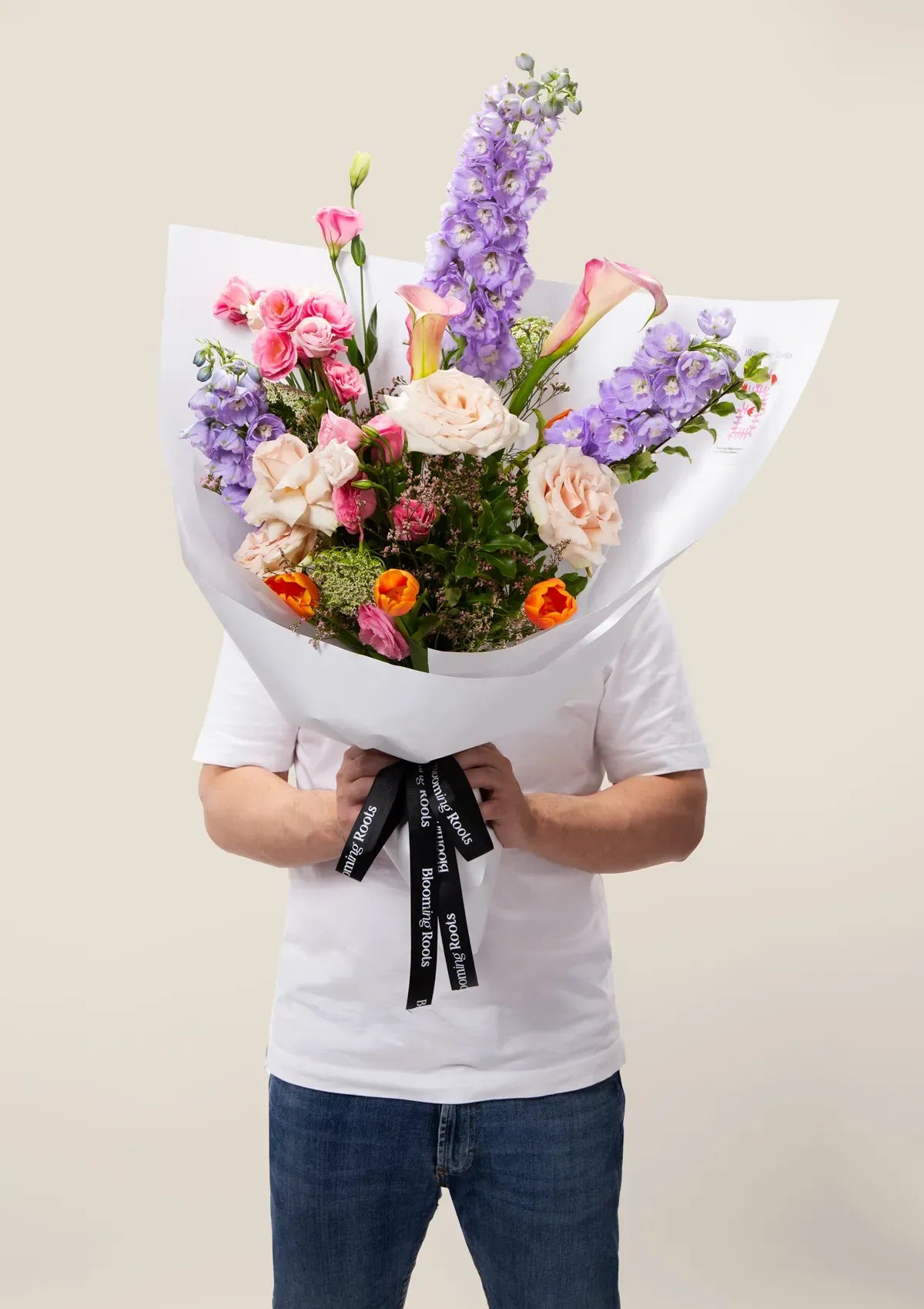 A man holding Harmony Medley Bouquet from Blooming Roots.