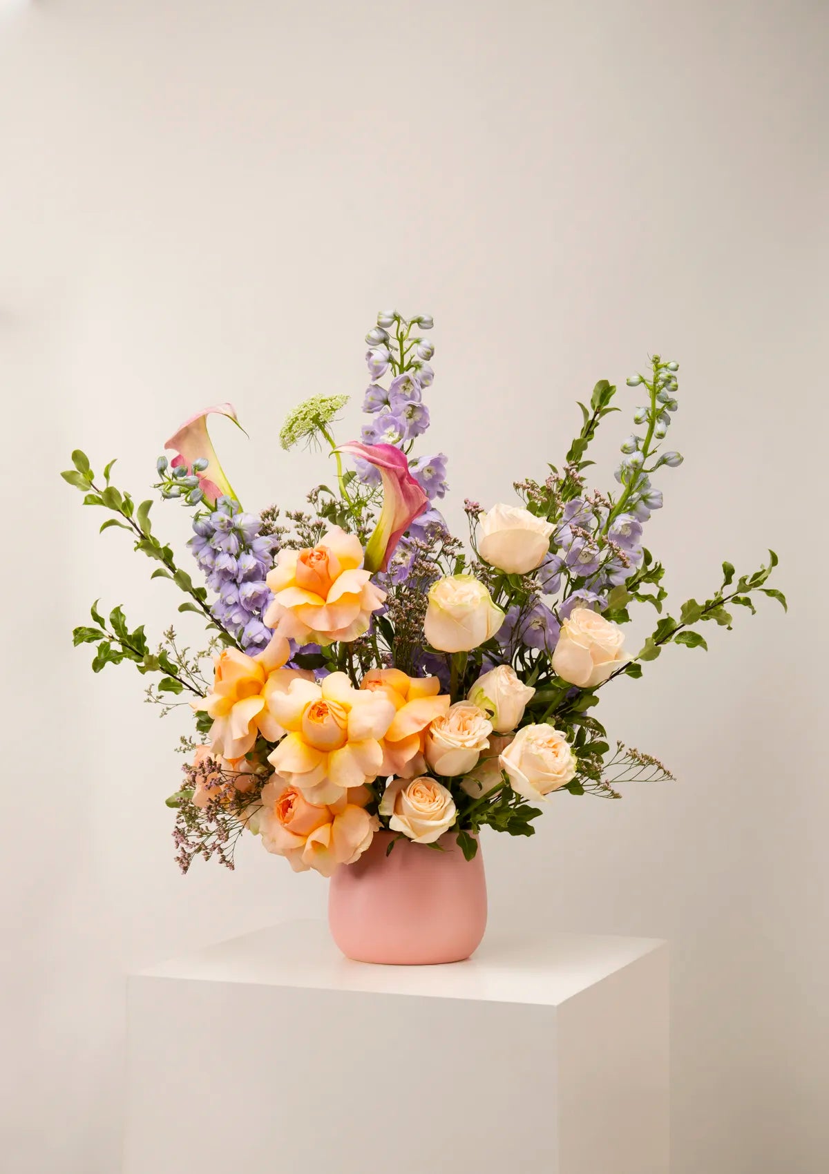 Ceramic Pink Romance Vase by Blooming Roots with orange, white, green, purple flowers.