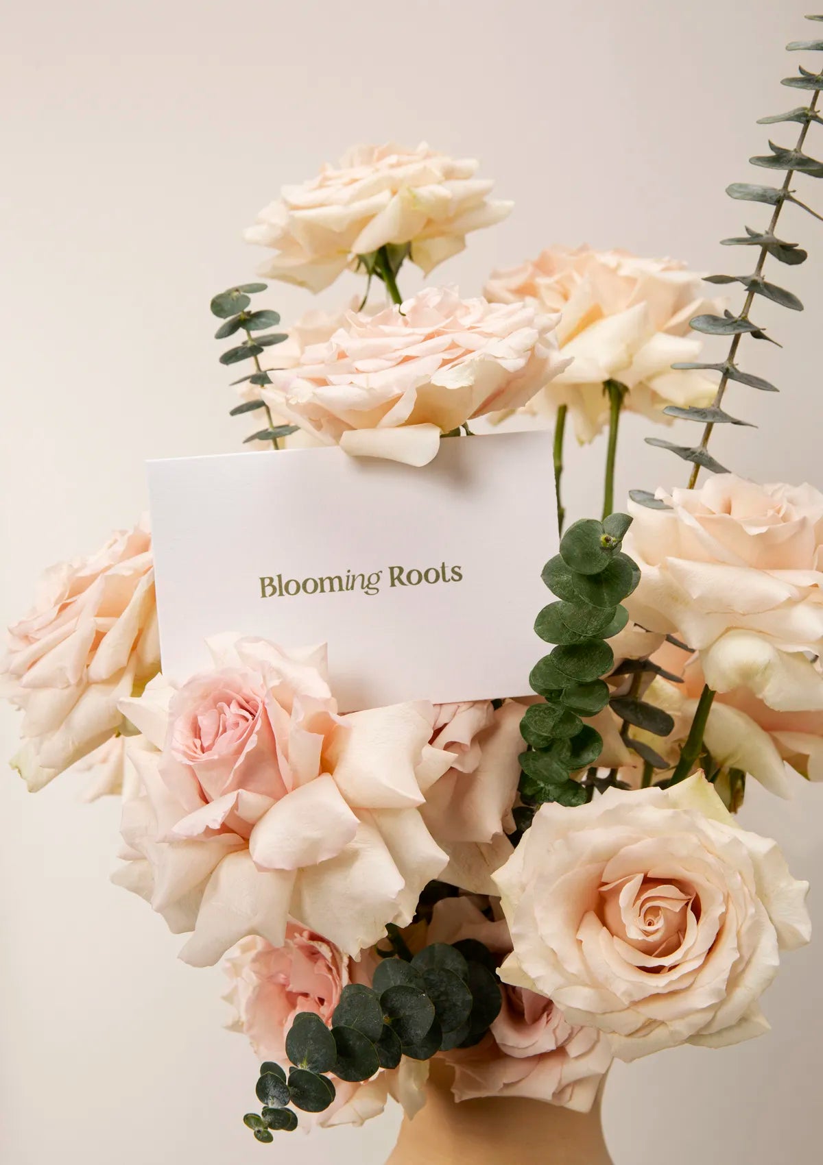 Clay light Beige Quicksand Vase by Blooming Roots with a greeting card that has a logo on it.