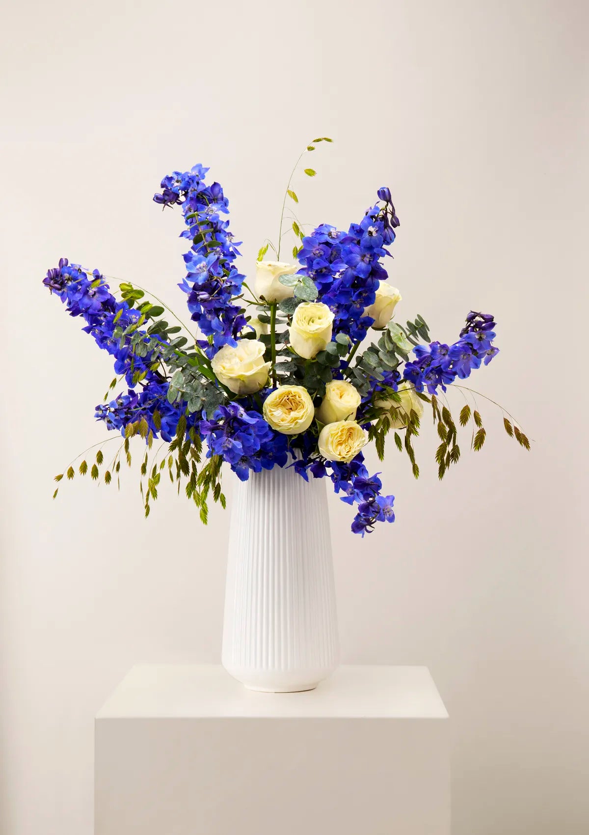 White Ceramic Royal Vase by Blooming Roots with blue and white flowers.