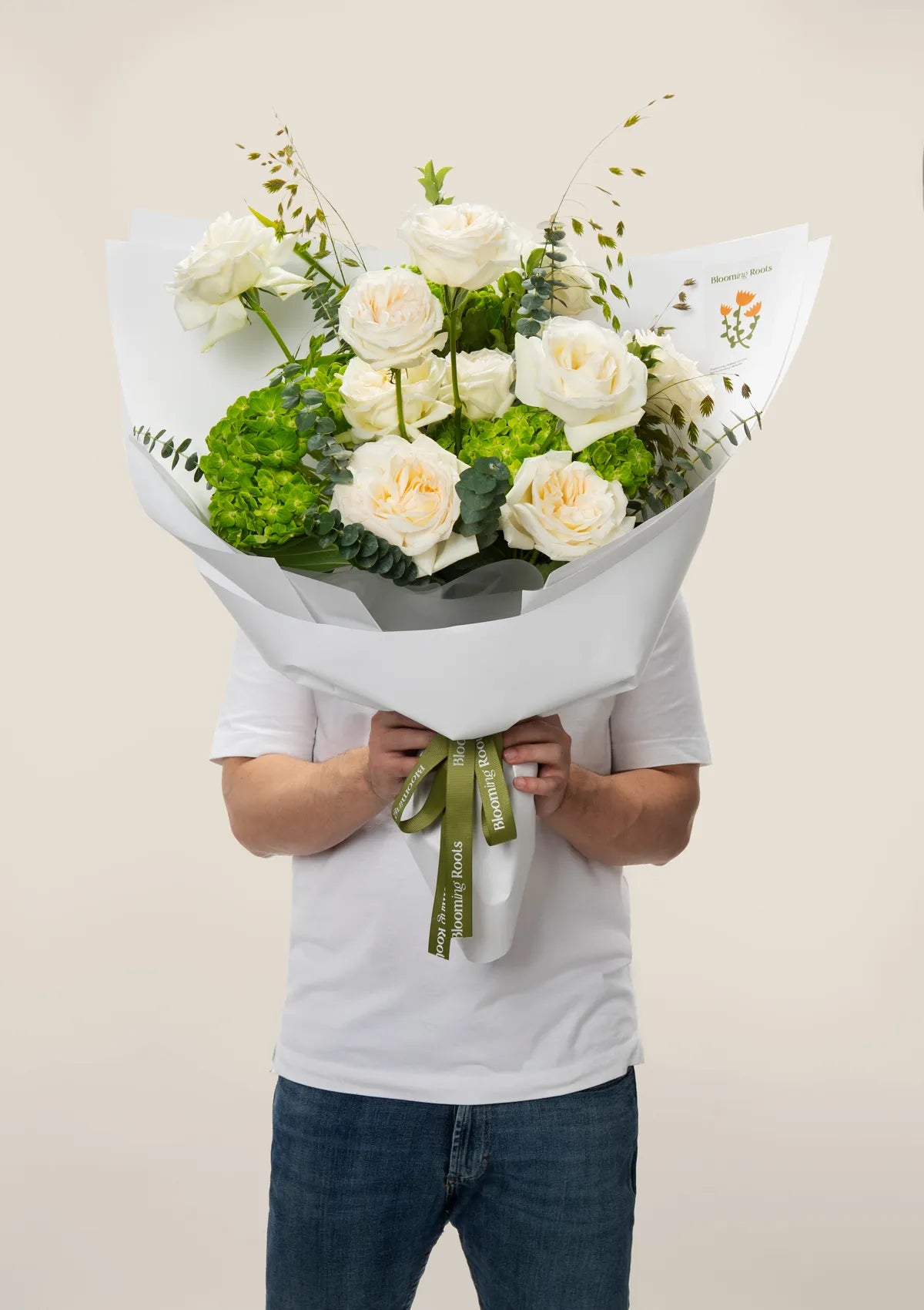 A man holding Zen Garden Bouquet from Blooming Roots.